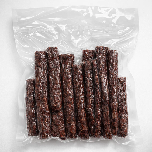 Vacuum-sealed package of dried wors on a white background